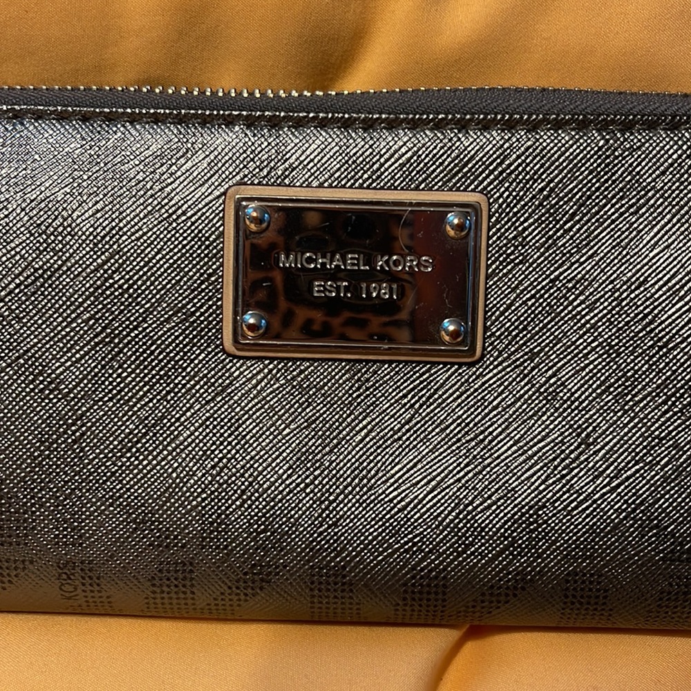Silver Michael Kors zipper wallet with MK pattern